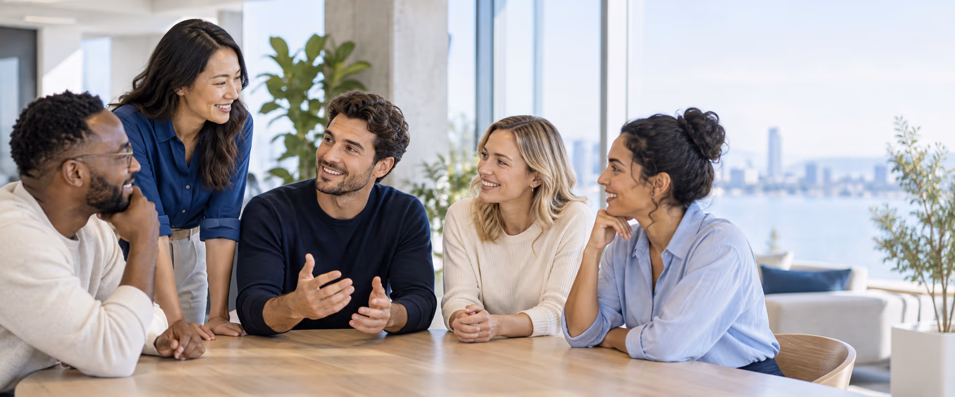 A customer-facing team sharing context around a table